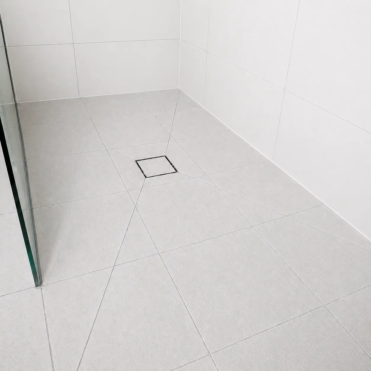Close-up of tile grouting work inside a shower