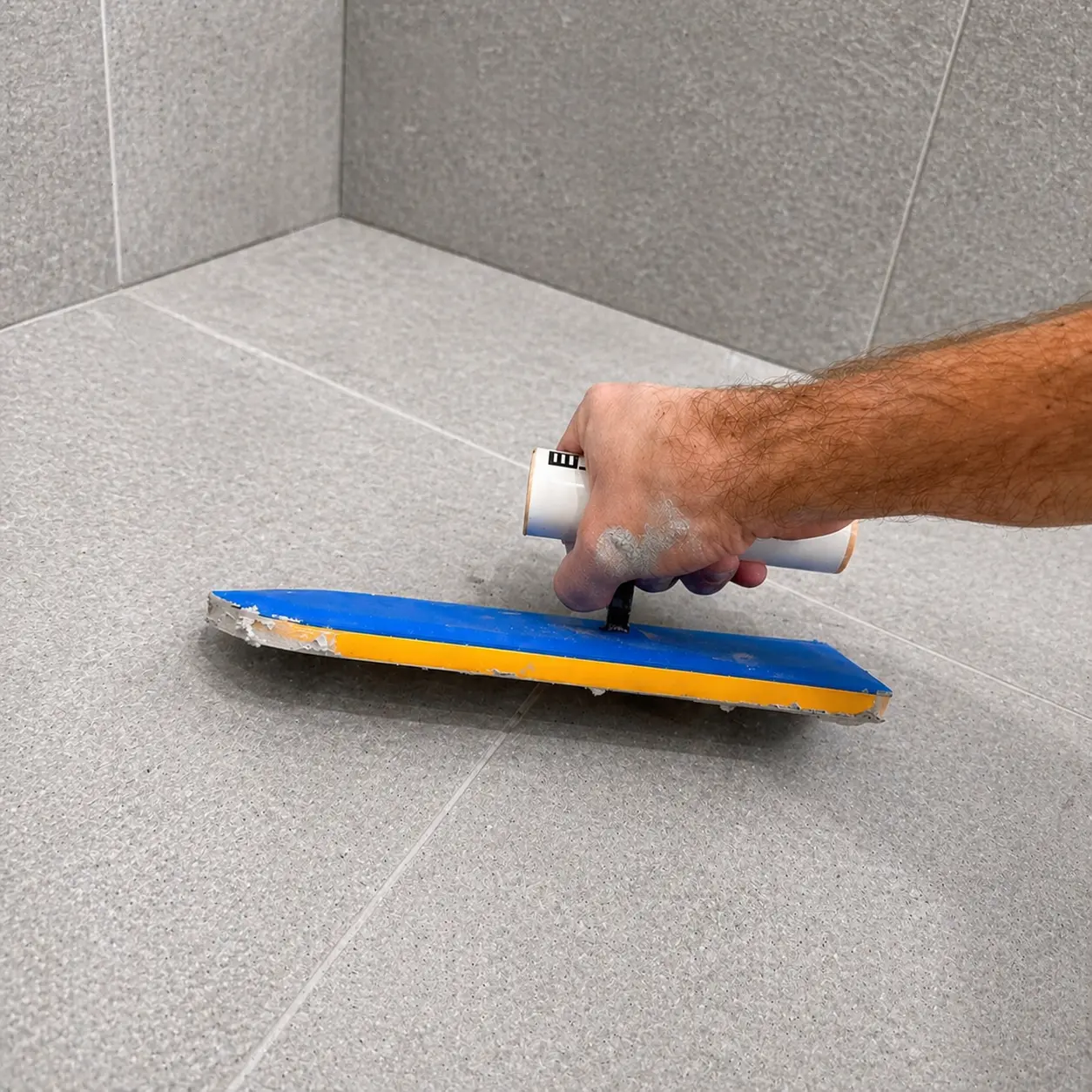 Freshly regrouted shower floor and wall tiles